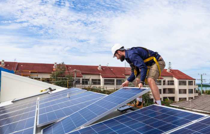 man installing solar panels