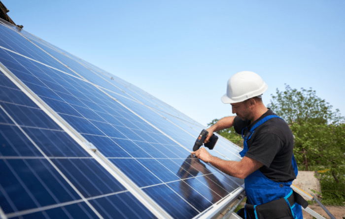 man installing solar panels